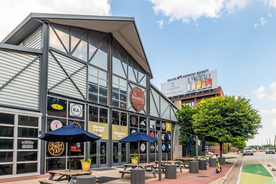 Exterior of the Dallas Farmers Market, which is populated with produce, food and crafts vendors.