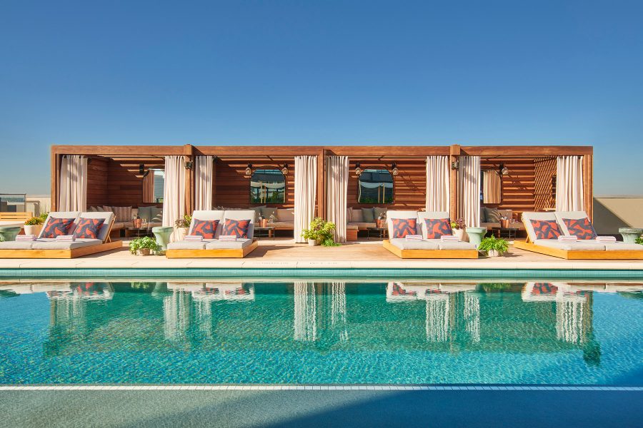  The rooftop pool at Virgin Hotels Dallas, lined with comfy lounge chairs.
