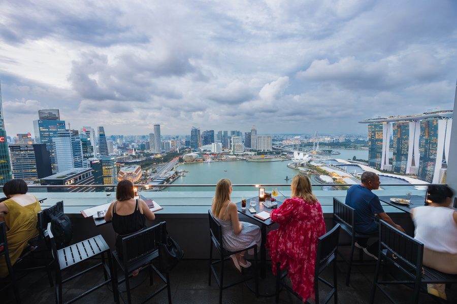 Diners seated at LeVeL33’s wrap-around Balcony look out over Marina Bay and Marina Bay Sands while dining.