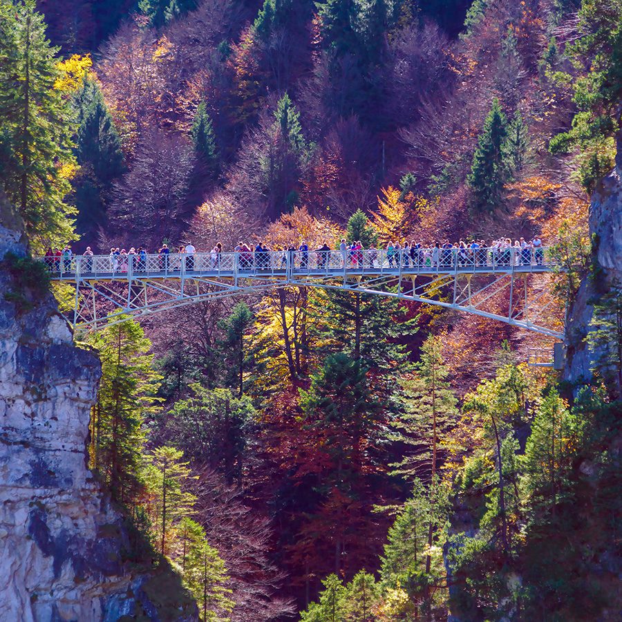 From afar, the Marienbrucke, a suspended bridge overlooking the Neuschwanstein Castle, bustles with people. 