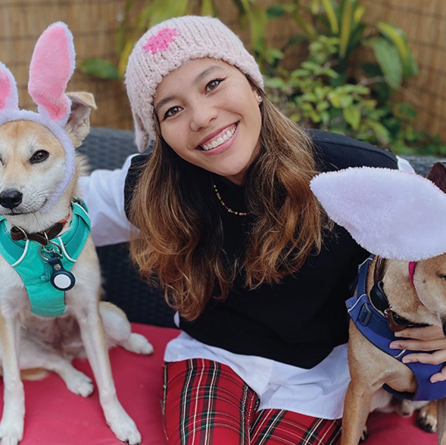 Portrait of Isabella Luk alongside her two dogs Tia and Jaffa.
