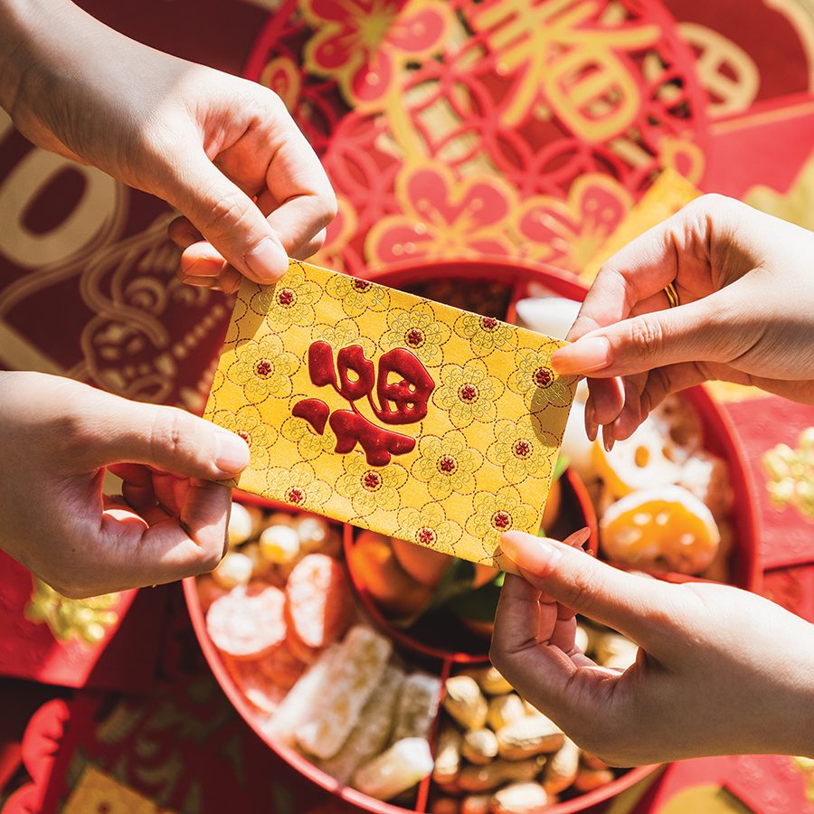 A golden lai see packet being exchanged.