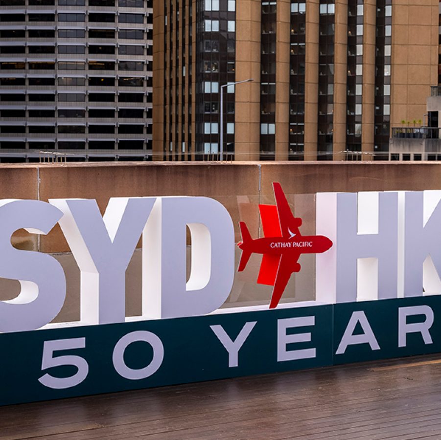 A large text display spelling out “SYD HKG 50 YEARS” in Sydney. 