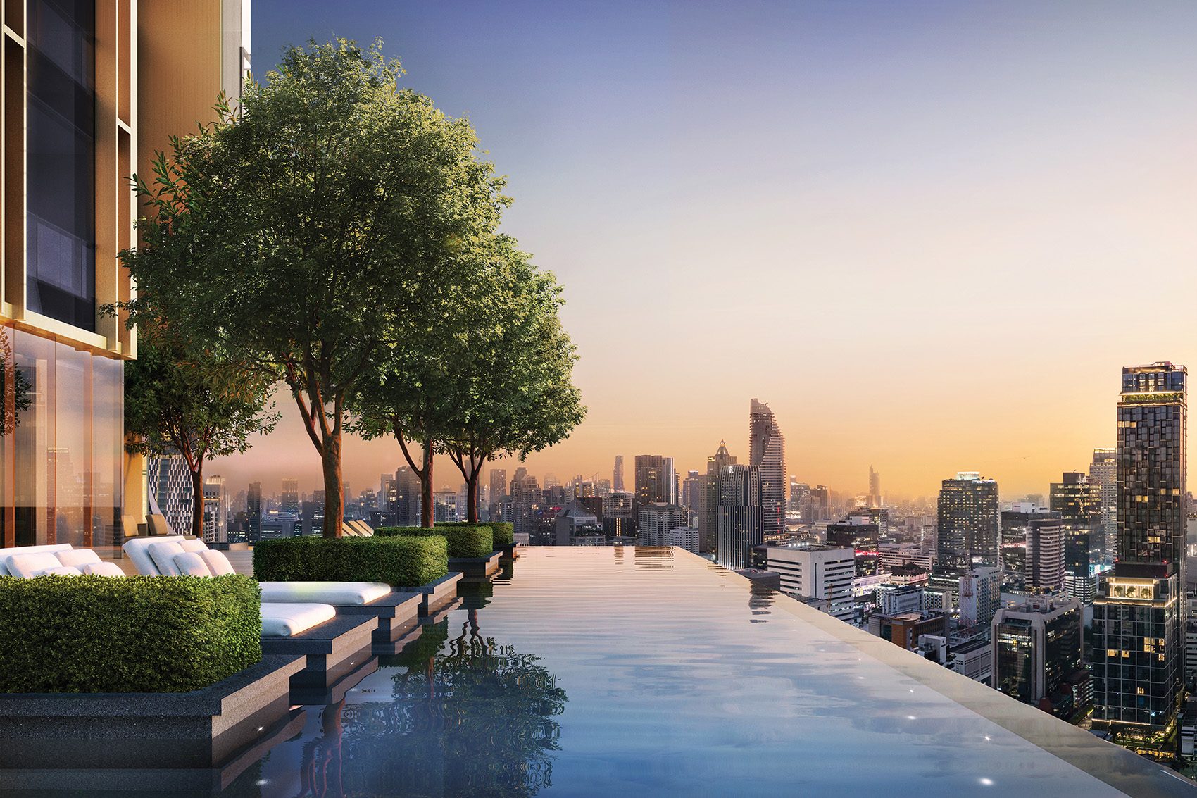 Aman Nai Lert Bangkok’s outdoor infinity pool looks out across the city of Bangkok, Thailand in the evening.