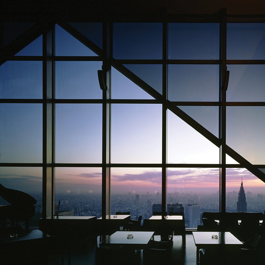 Interior of a restaurant in Park Hyatt Tokyo during the evening, which looks out across the city of Tokyo.