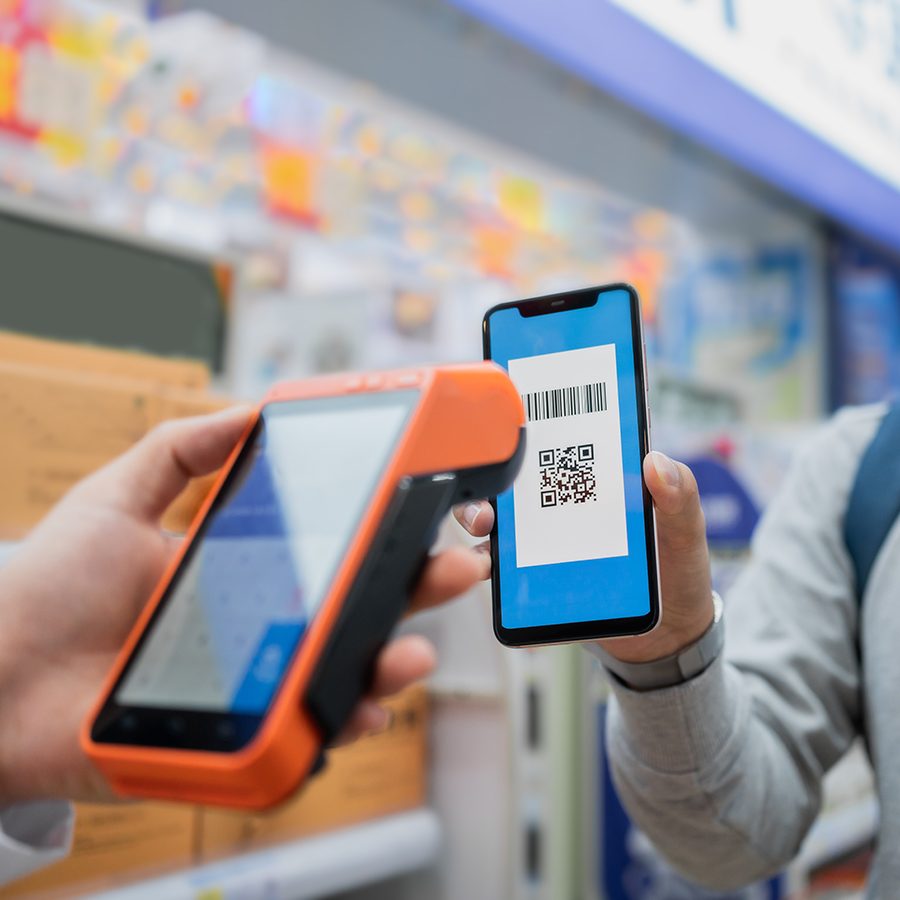 A man shows his AliPay QR code for payment.  