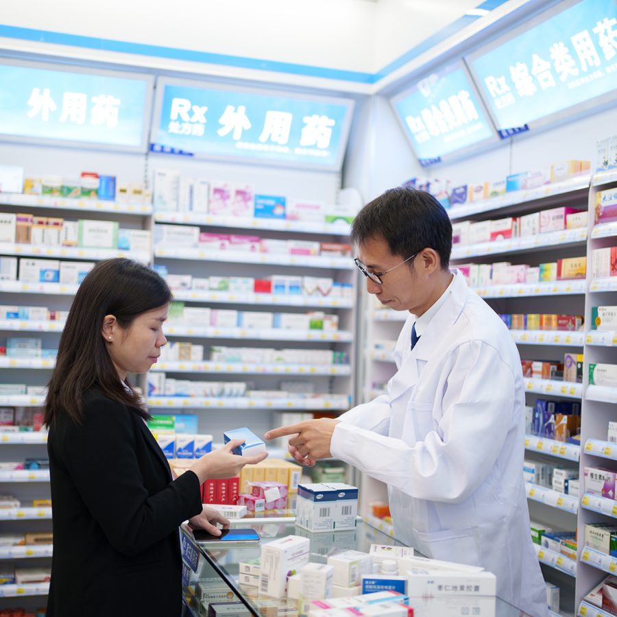 A woman purchases over-the-counter medication at a qualified pharmacy in the Chinese Mainland.