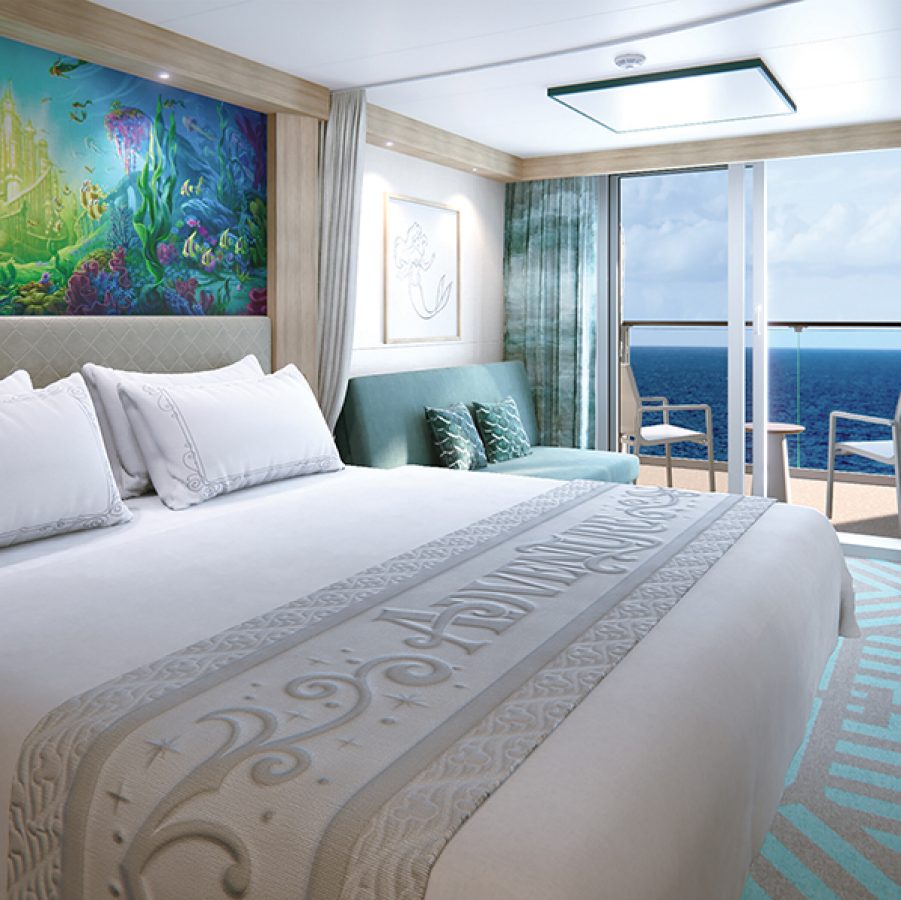 Interior of a guest room with a verandah and ocean views aboard Disney Adventure.