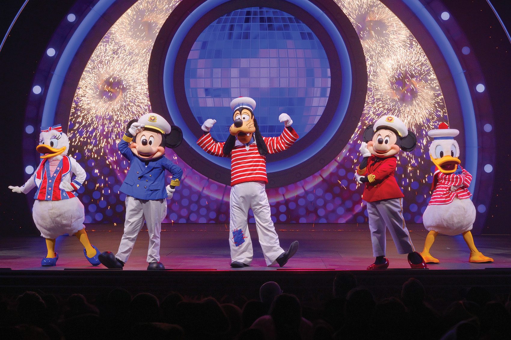 Disney characters perform on stage aboard Disney Cruise Line’s Disney Adventure.