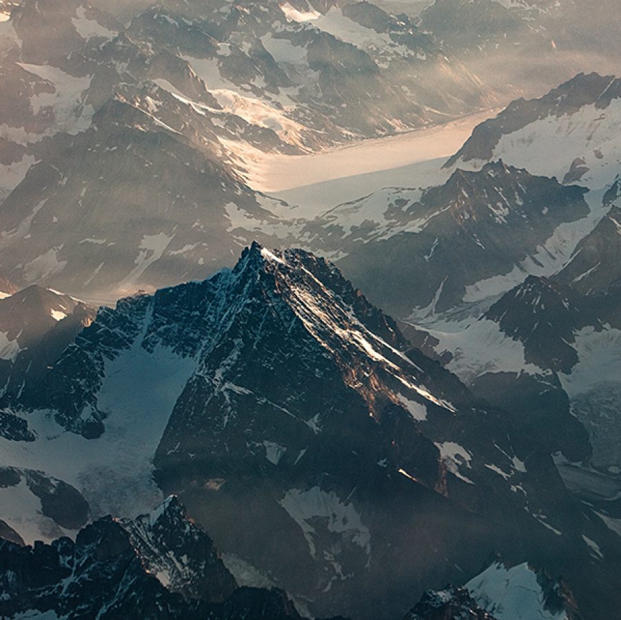A bird’s eye view of a snowy mountain range in Alaska.