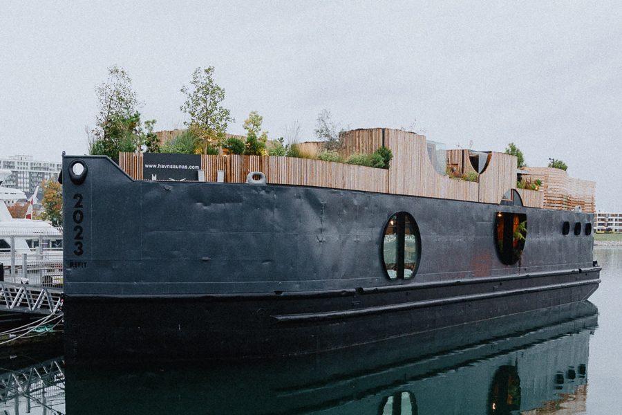 Havn, a floating spa set on the deck of a repurposed barge in Victoria, British Columbia, on a cloudy day. 