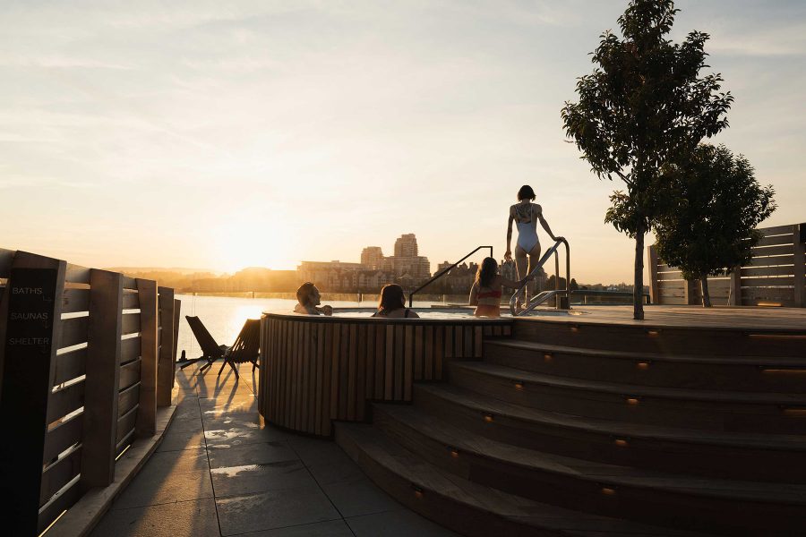 Four people on an outdoor deck at Havn, Victoria, at sunset. 
