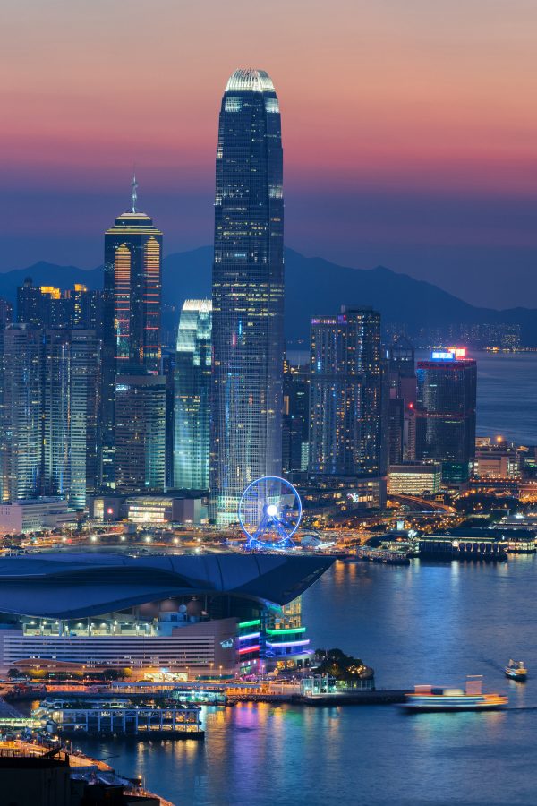 An evening shot of Hong Kong skyline after sunset with a view of IFC and the Hong Kong Exhibition Centre by Victoria Habrour