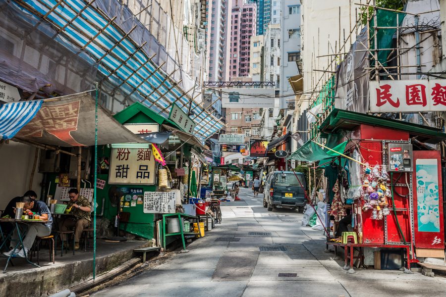 A street view of food stalls, skyscrapers and bamboo scaffolding at SoHo, Central in Hong Kong