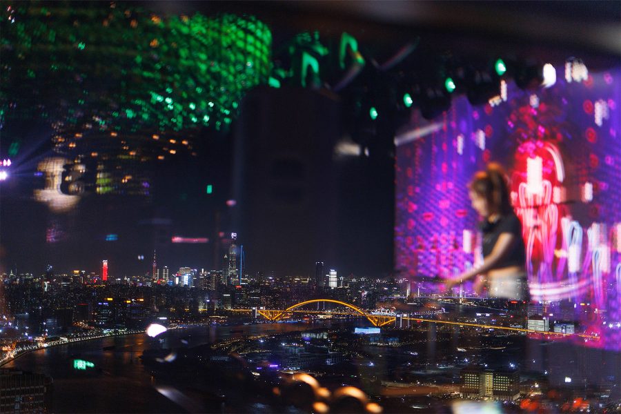 An interior view of the bar featuring a bartender preparing drinks at MGM Shanghai West Bund. 
