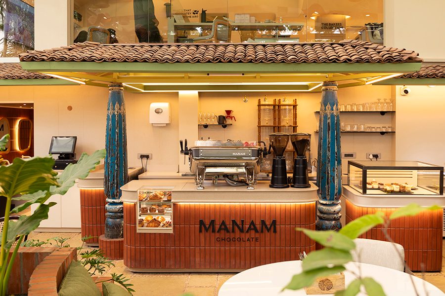 A view of a coffee counter with a cake display at Manam Chocolate Karkhana café in Hyderabad