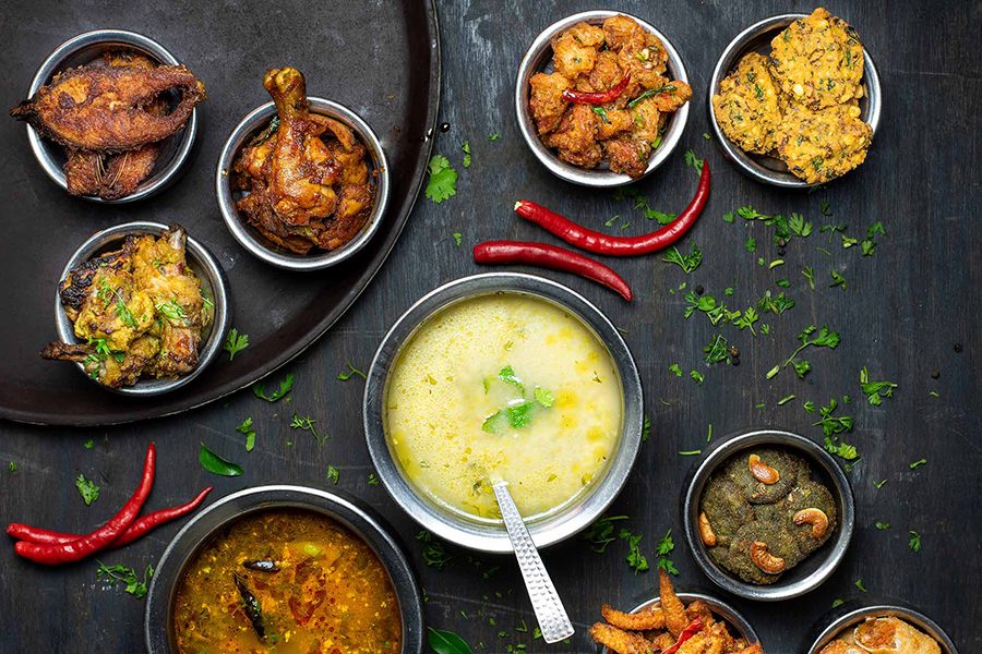 A top-down group shot of various curried dishes and appetisers, served at Rayalaseema Ruchulu in Hyderabad