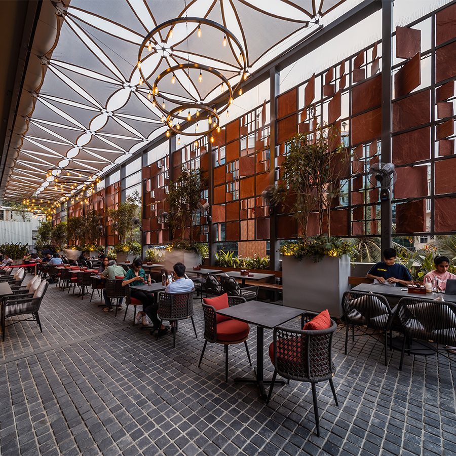 A view of the shaded outdoor seating area at coffee shop Roast CCx in Hyderabad