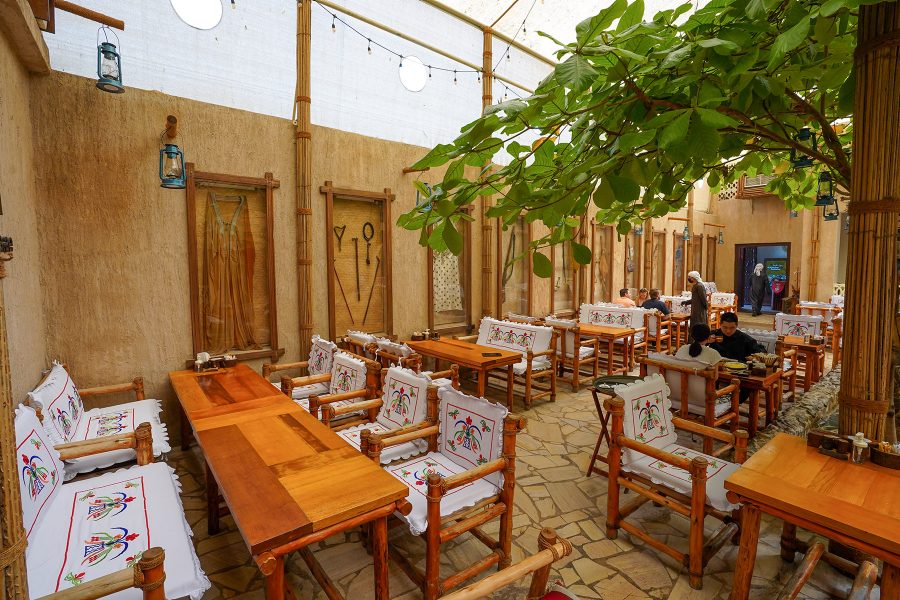 Tables and chairs in the courtyard of Al Khayma Heritage Restaurant, Dubai.