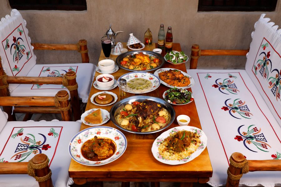 A table covered in plates of food at Al Khayma Heritage Restaurant in Dubai.