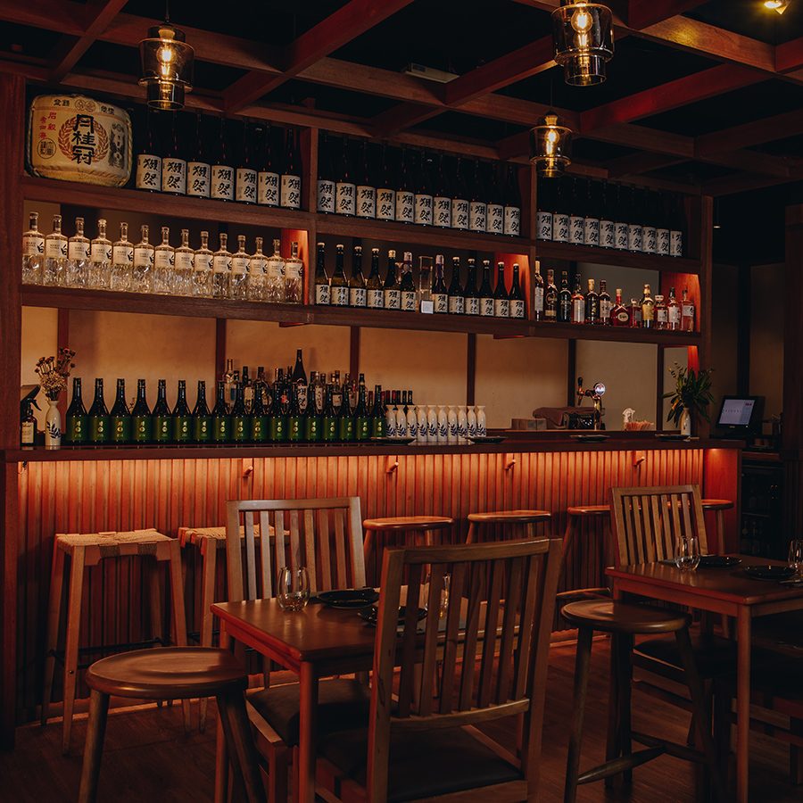 Tables and chairs in front of the bar at Kinoya, Dubai.