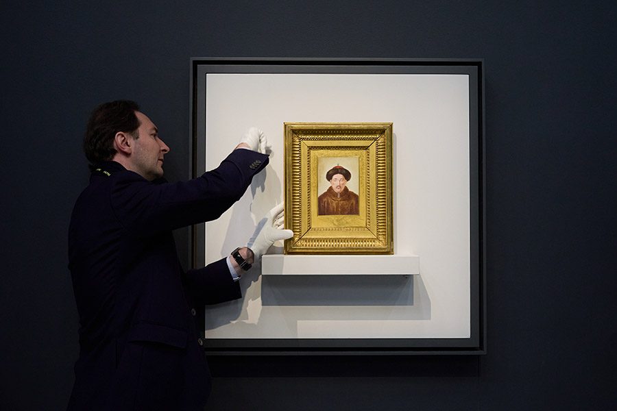 Man displaying artwork from The Forbidden City and The Palace of Versailles: China-France Cultural Encounters.