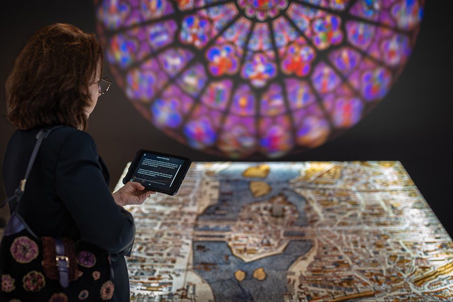 Person viewing an exhibit at Notre-Dame de Paris: The Augmented Exhibition.