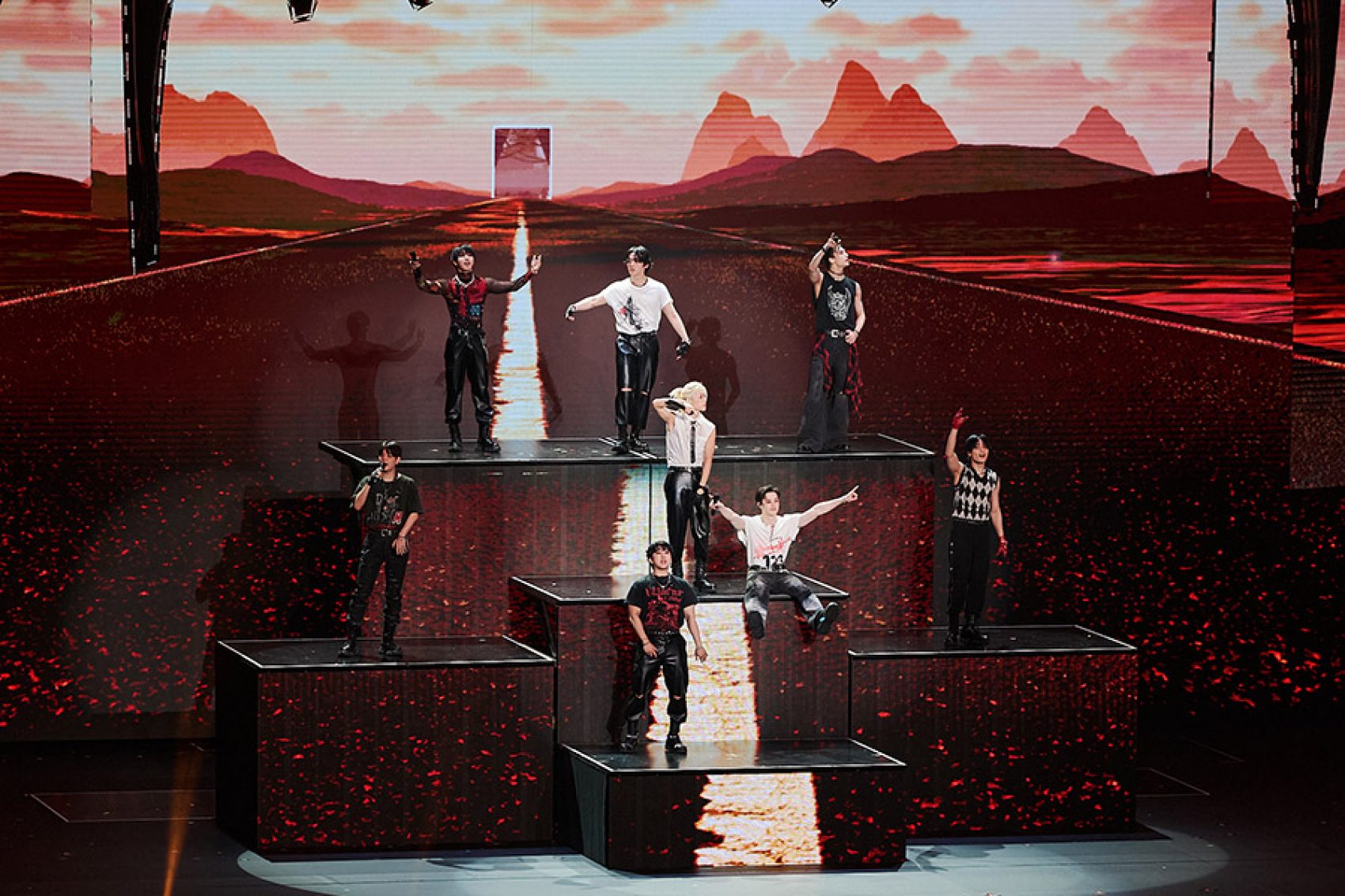 Stray Kids performing on a multi-level platform. 