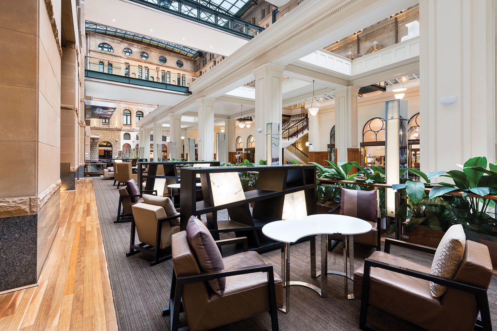 Brown tables and chairs at the Bar restaurant at the Fullerton Hotel Sydney.