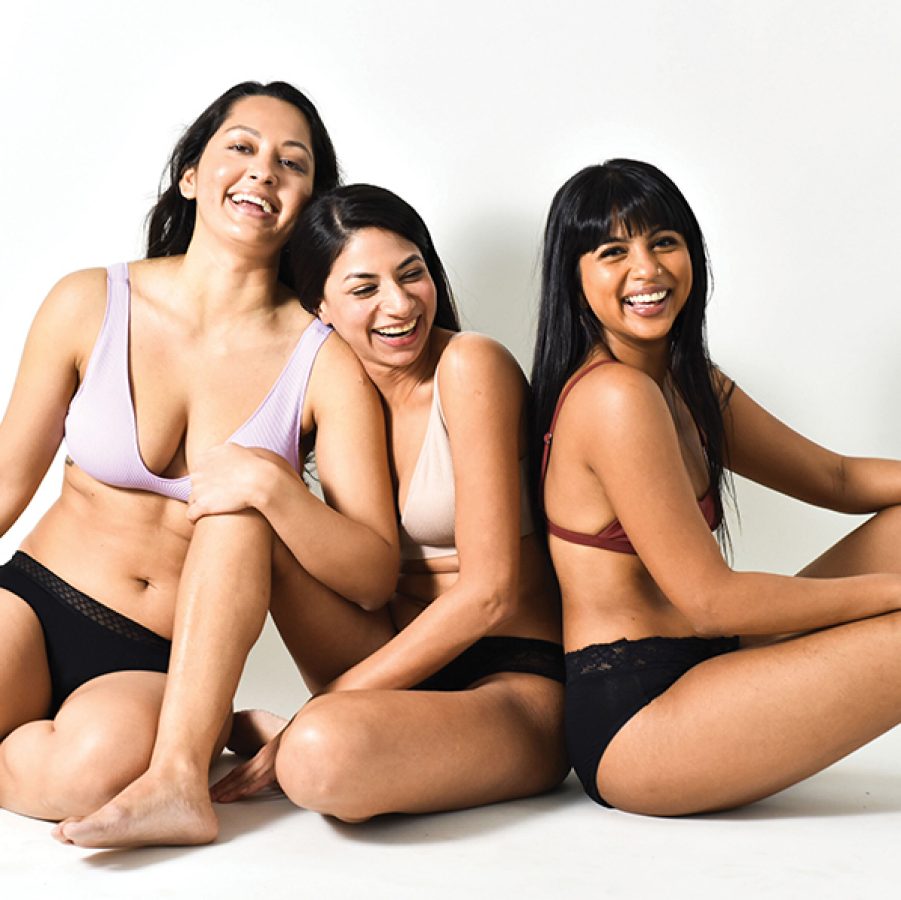 Three south Asian women smiling and modelling for Hong Kong women's garment brand Nushu