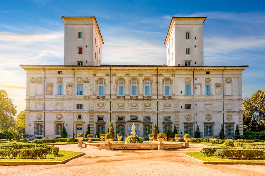 View of the entranceway and gardens surrounding Villa Borghese.