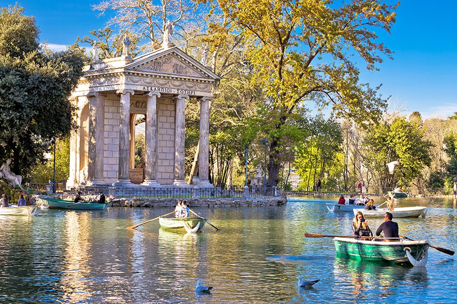 People rowing boats on the water on Villa Borghese’s grounds.