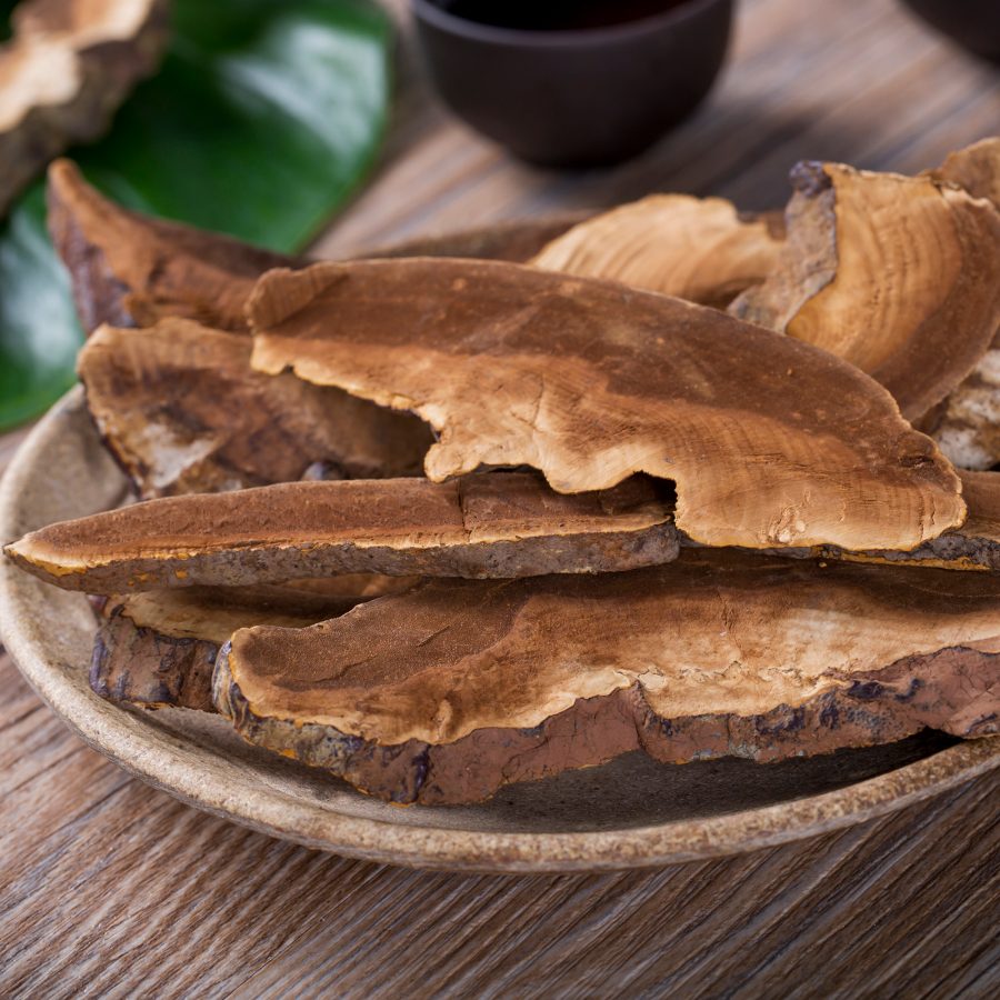 A plate of dried lingzhi on a wooden table. 