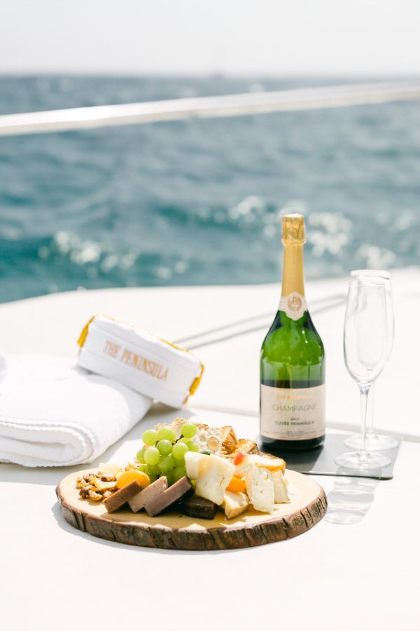 A bottle of Champagne and a cheese board aboard The Peninsula New York’s yacht. 