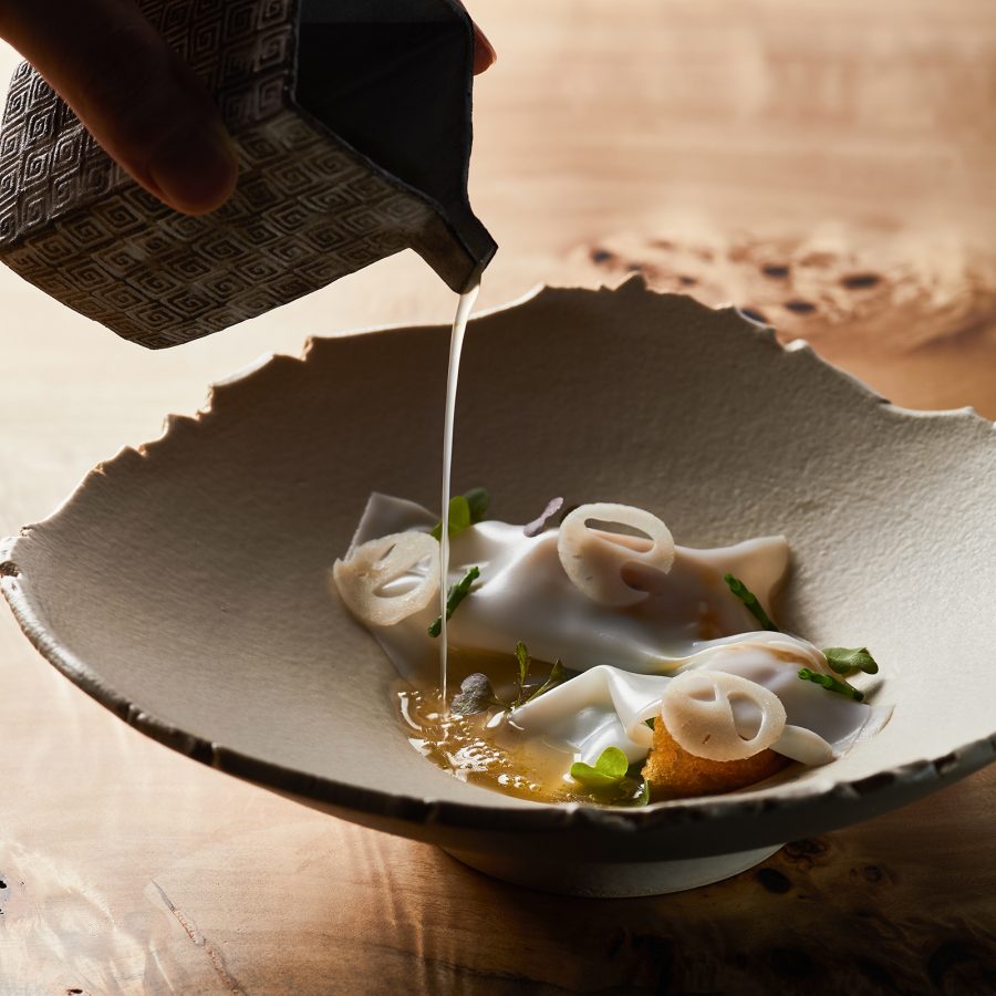 A bowl of food with liquid being poured into it at Avant.