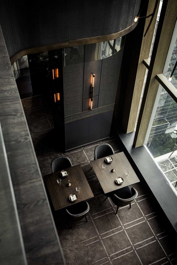A high-angle view of the black wood interiors at Ensue. 