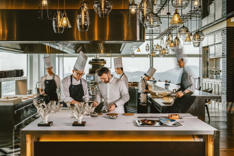 A group of chefs in the open kitchen area at OPUS 388.