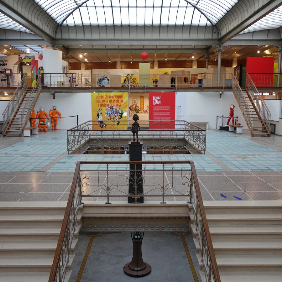 The interior of the Comics Art Museum features two spacious mezzanine levels connected by two sets of staircases. Above is a conservatory-style glass ceiling.  