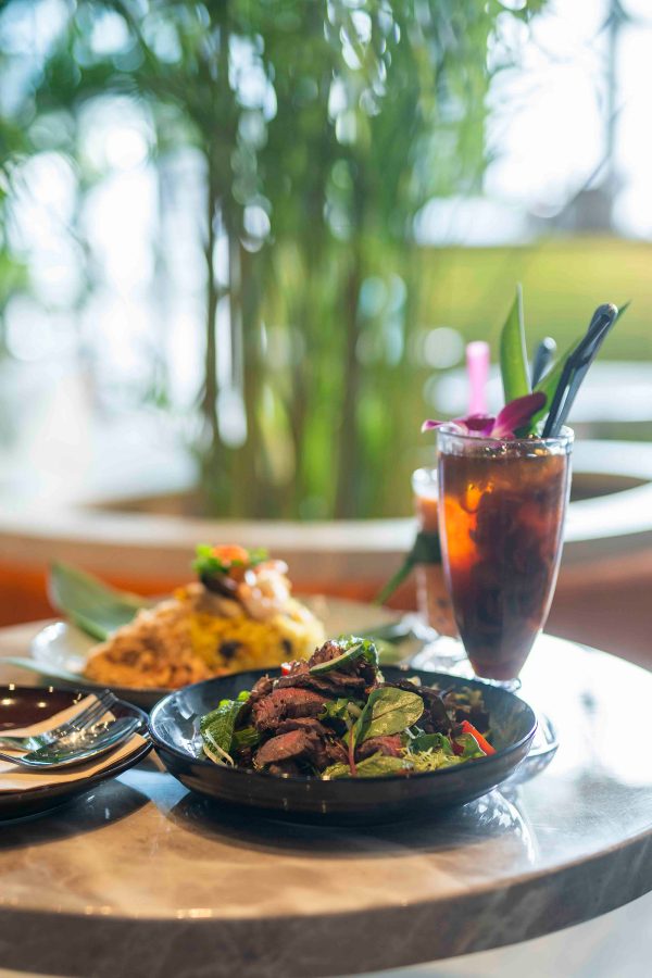 A table with plates of food and a drink at Groundswell, Hong Kong. 