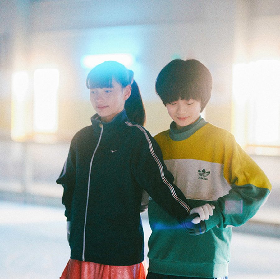 In a scene from the film My Sunshine, a girl and boy – Sakura (Kiara Takanashi) and Takuya (Keitatsu Koshiyama) – hold hands as they prepare to skate on an indoor rink. 