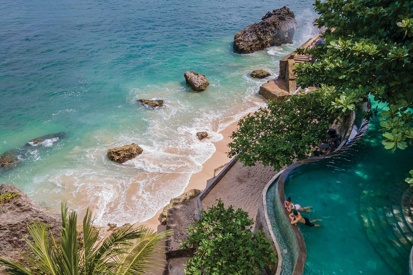Couple in an infinity pool overlooking the sea in Ayana Resort