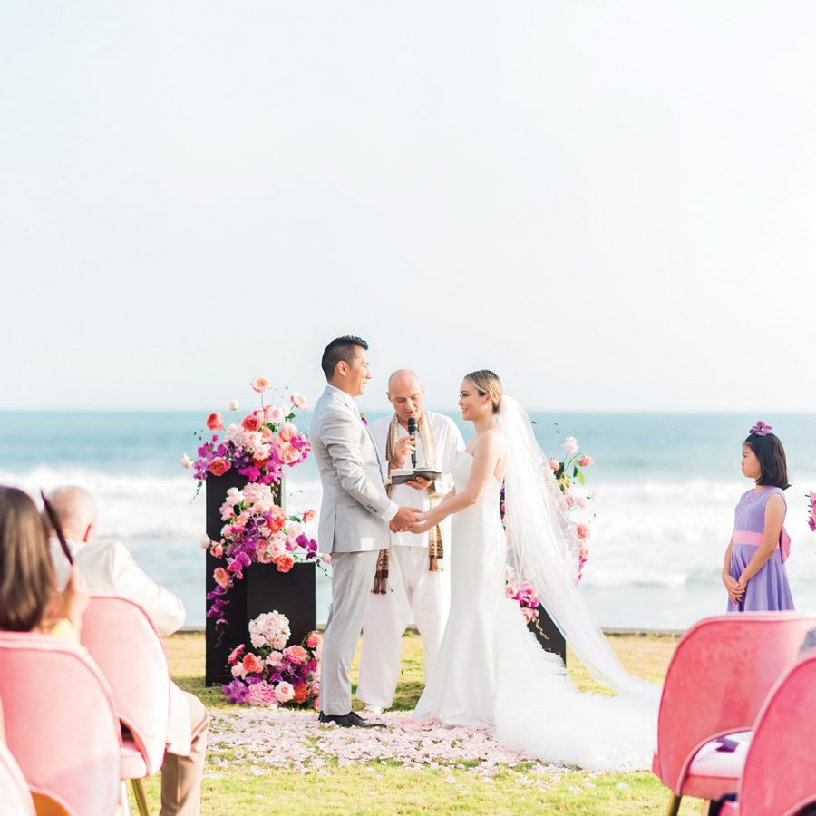 Married couple during their ceremoy surrounded by guests