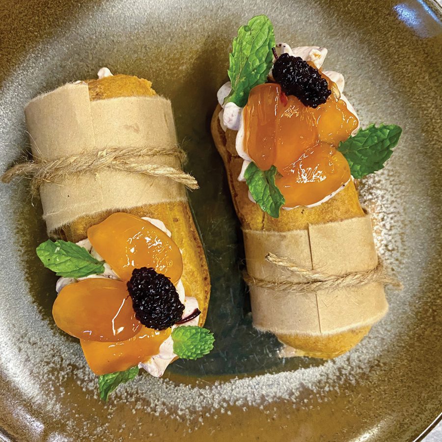 Mini dessert banh mi topped with cream and glazed fruit at Mùa, Hoi An. 