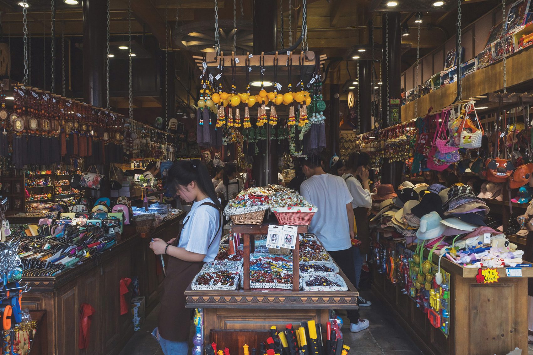 People browse colourful souvenirs on displays at a shop on Hefang Street.