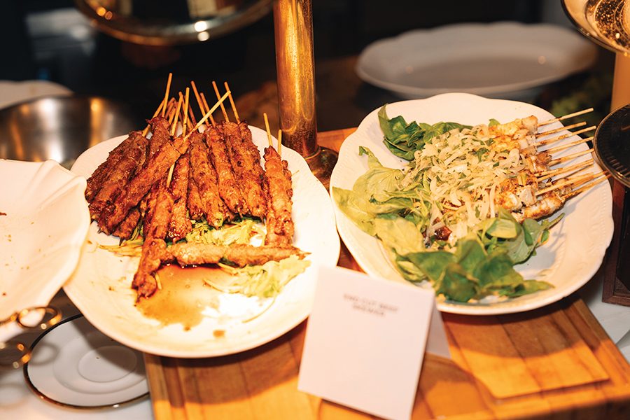 Plates of beef skewers on a counter, at The Rescued Feast 3.0.