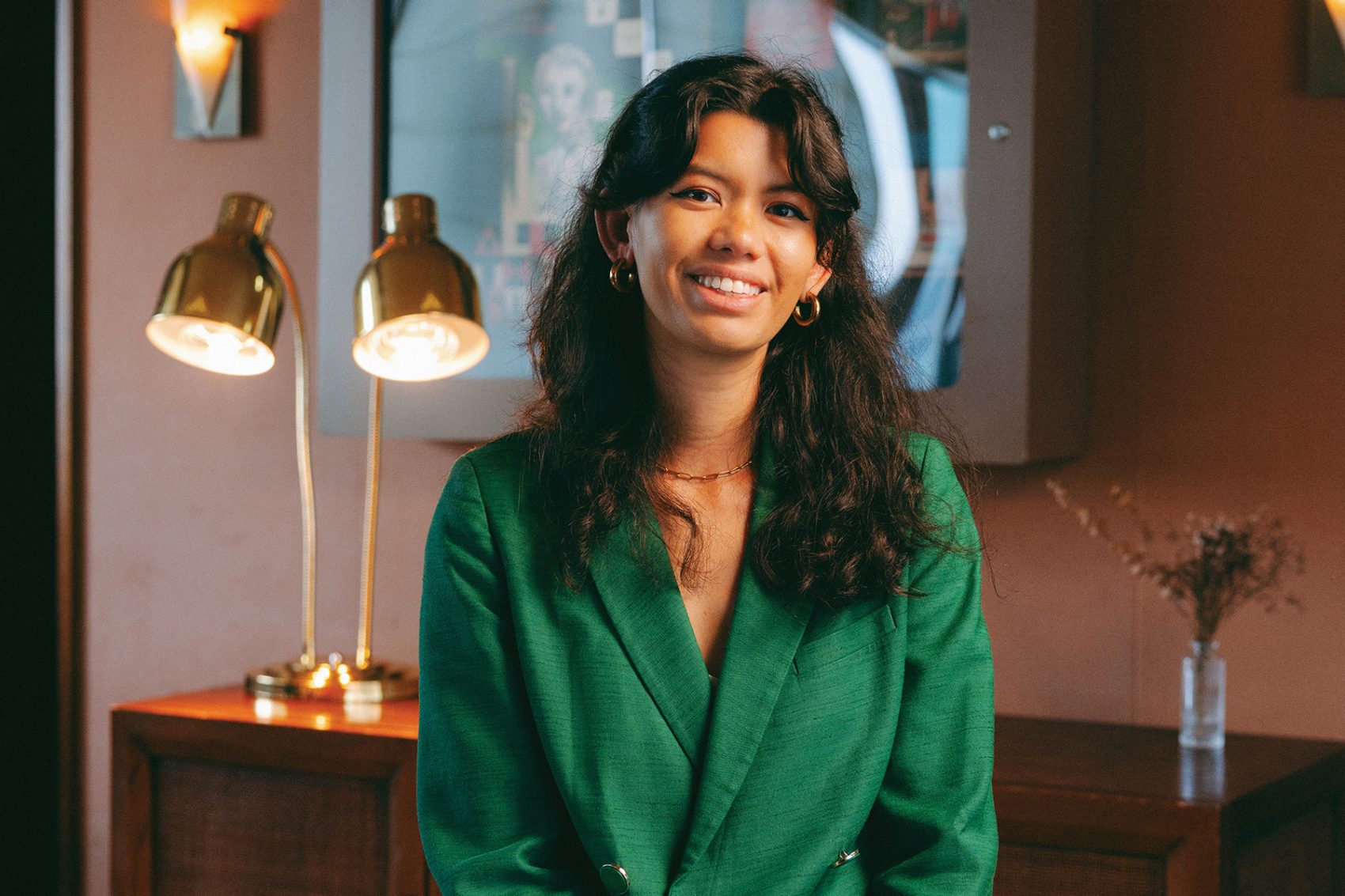 Carla Martinesi is pictured smiling in a green jacket at Soho House.