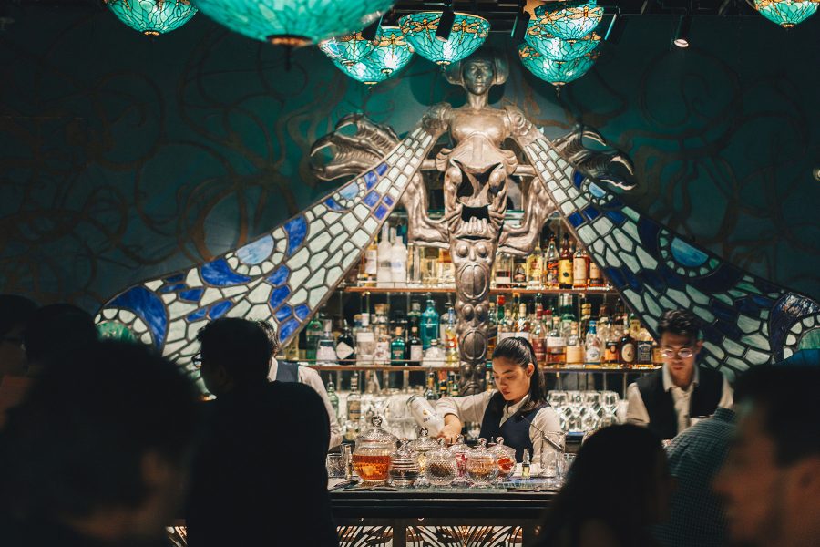 Bartender makes cocktails at Dragonfly surrounded by patrons