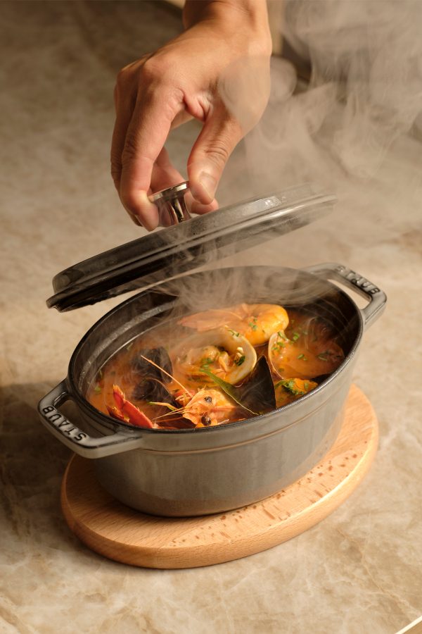A pot of soup broth uses ingredients in new ways to reduce food waste.