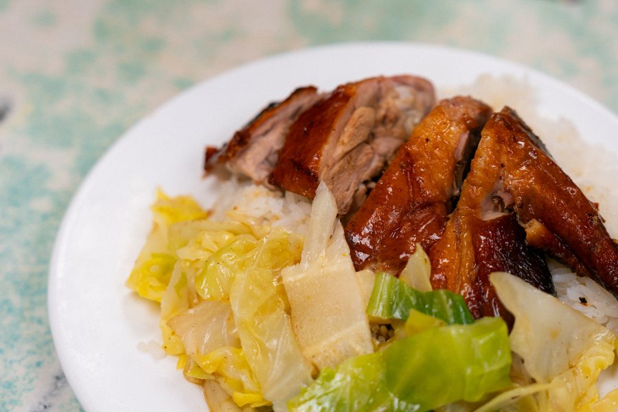 A plate of roasted duck leg rice and vegetables with a bowl of mutton curry served at Wai Kee halal duck restaurant at Bowrington Road Market and Cooked Food Centre, Wan Chai.