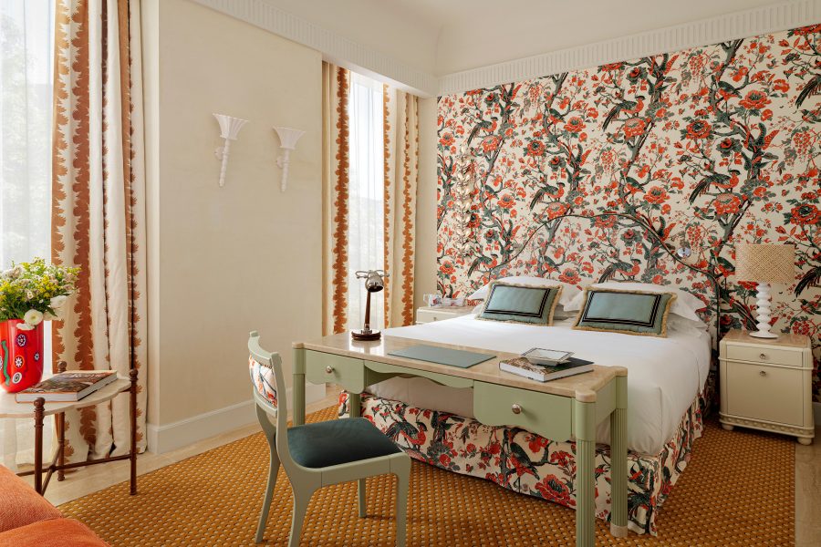 An interior view of a bedroom suite at Casa Monti hotel in Rome, decorated with floral designs.